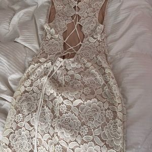 Beige dress by the knee that the front and back will fit a medium or large